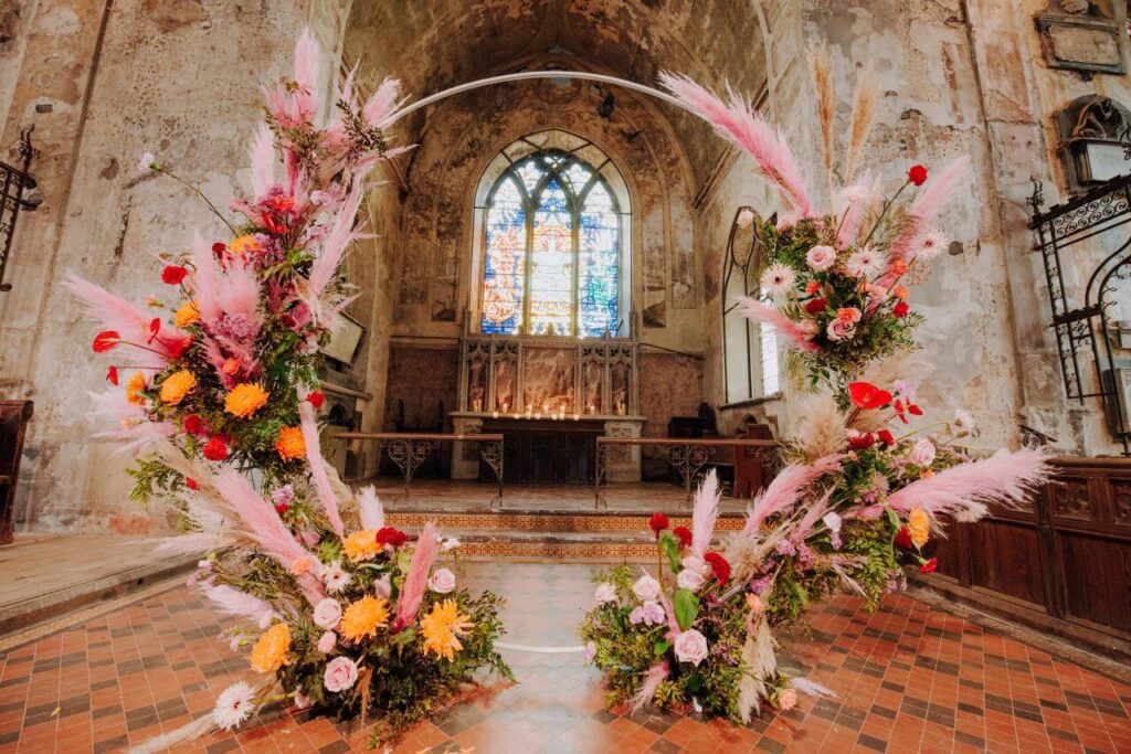 pink and red wedding flower arch
